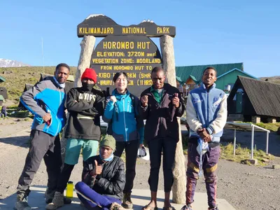 Climbers at the Horombo Hut sign, 3720m, Kilimanjaro
